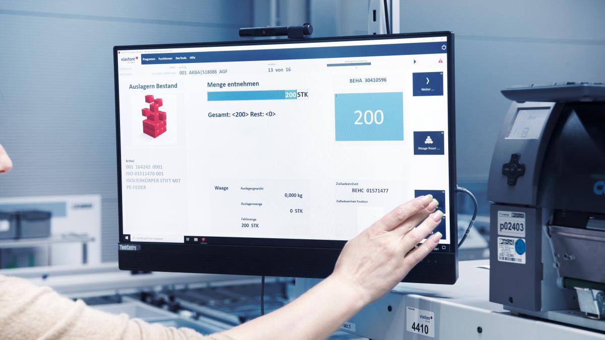 Warehouse employee operates screen with viadat warehouse management system from viastore