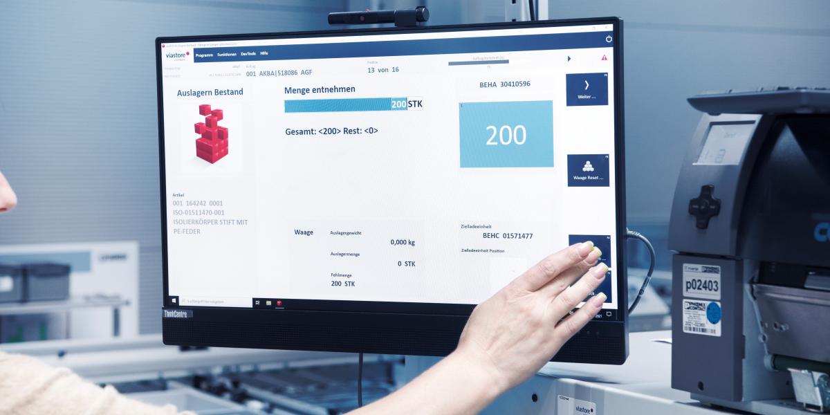 Warehouse employee operates screen with viadat warehouse management system from viastore
