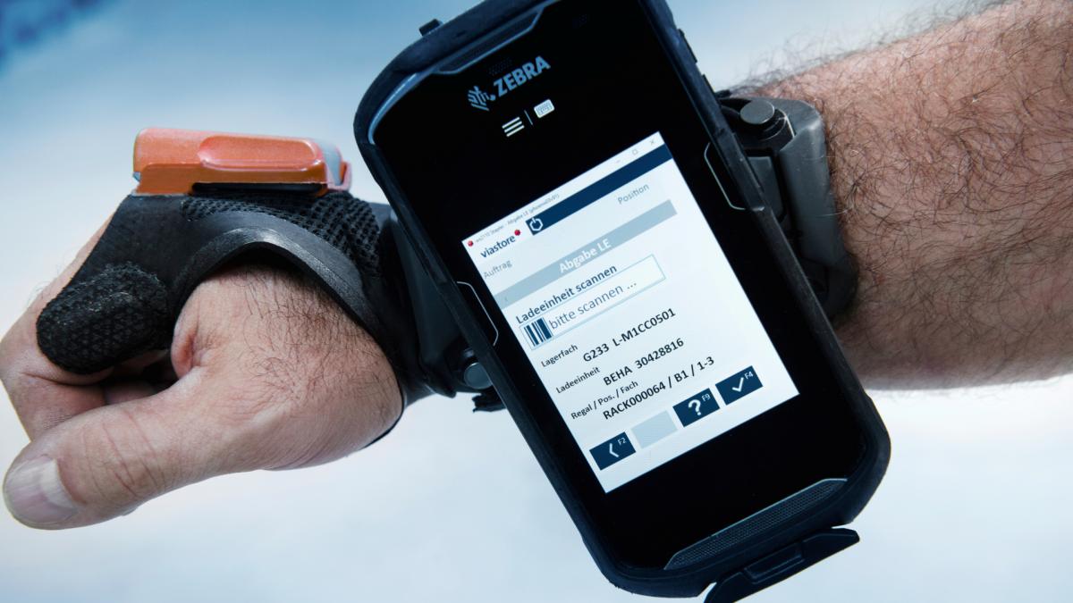 Glove scanner and handheld with viadat screen on the arm of an employee at Phoenix Contact in Herrenberg, Germany